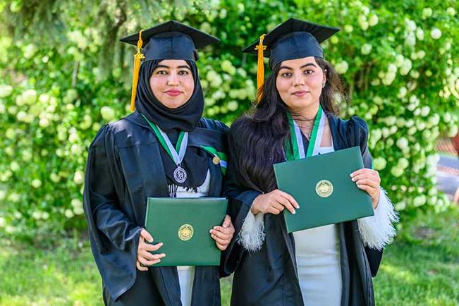 Parmina and Amina in graduation gowns